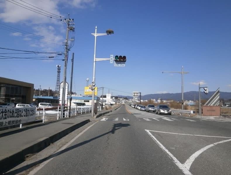 国道１５３号線を駒ヶ根方面から箕輪方面に向かい市役所入口の信号を直進します。